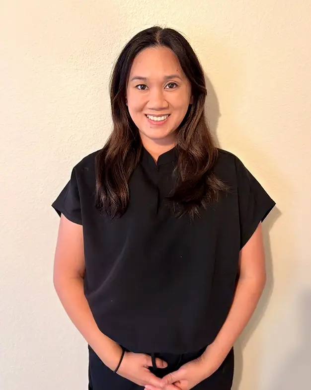 Erika, dental team member at Henderson dental practice, smiling at camera.